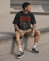Black Renegade dragon graphic tee seated lifestyle shot