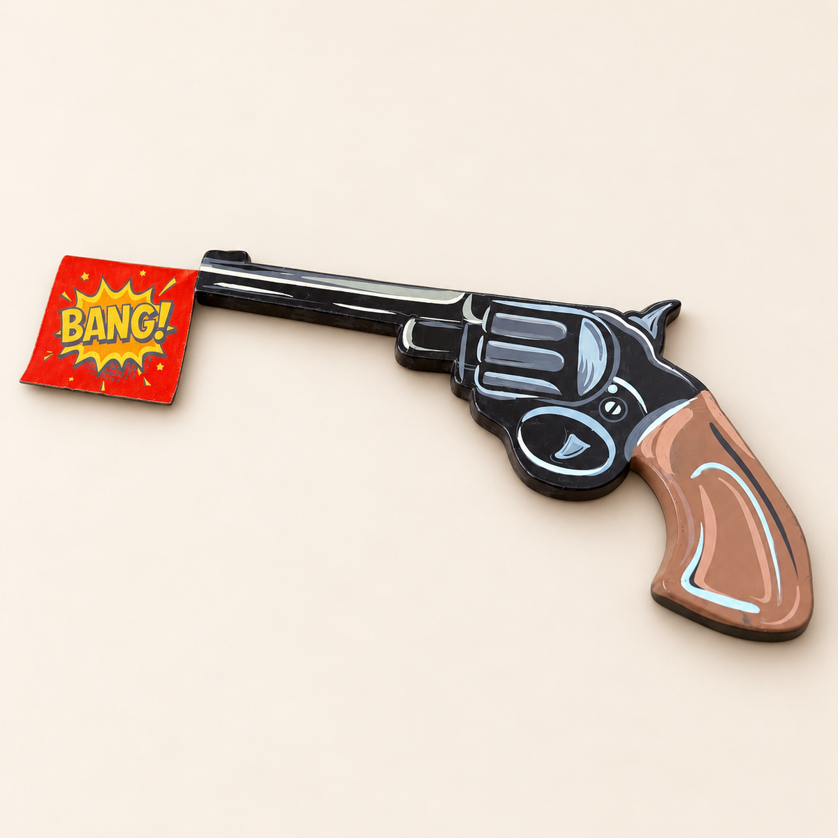 Angled view of hand-painted BANG! wall art showing the enamel finish, dark MDF edge and red comic flag