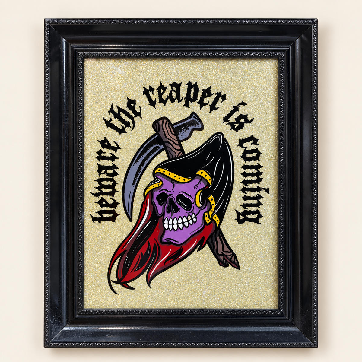 One-of-one Big Reaper painting with purple skull and gothic lettering on a gold glitter background in an ornate black frame — overhead view