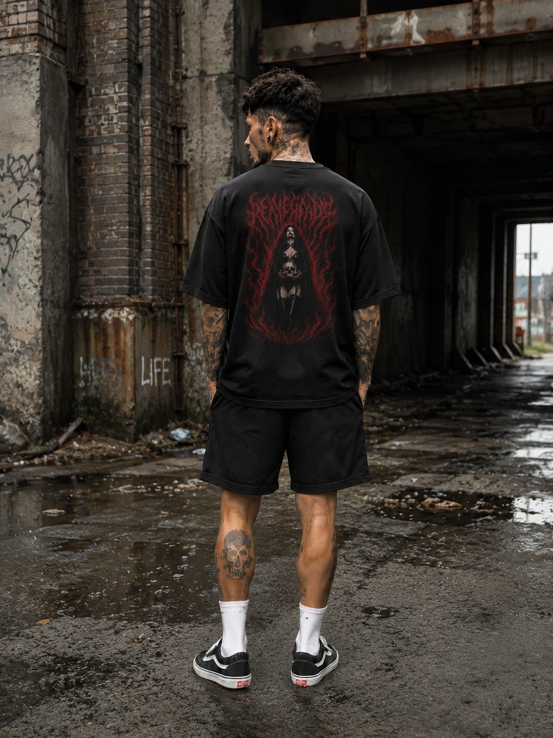 Original Renegade Blood Rite gothcore black graphic T-shirt male back view with shorts in abandoned industrial tunnel