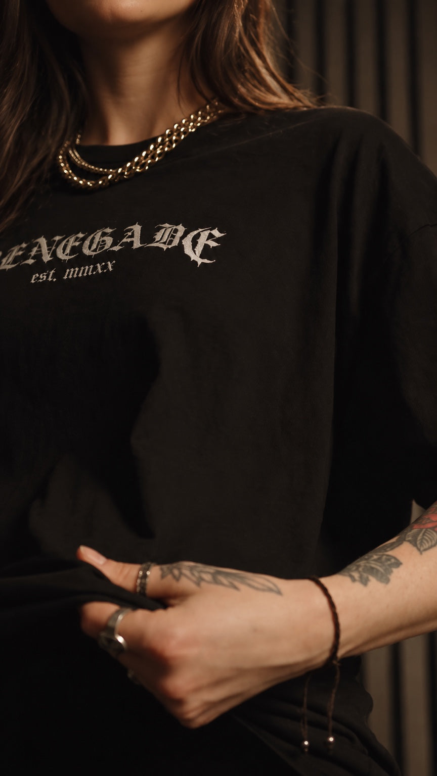 Woman wearing a black Original Renegade Core Classics graphic T-shirt with silver jewellery
