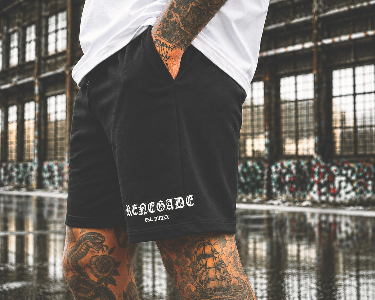 Close-up of white Original Renegade DTF leg print on black heavyweight shorts
