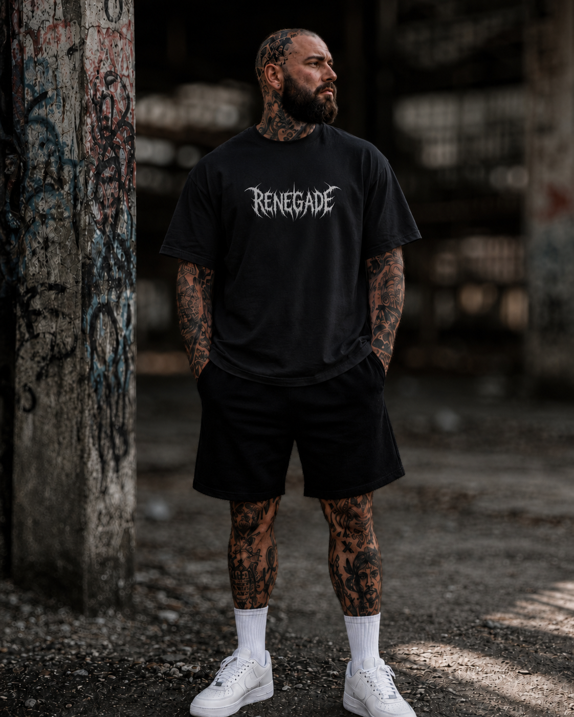 Tattooed male model wearing black Renegade Deathcore Logo Tee with white centre chest print
