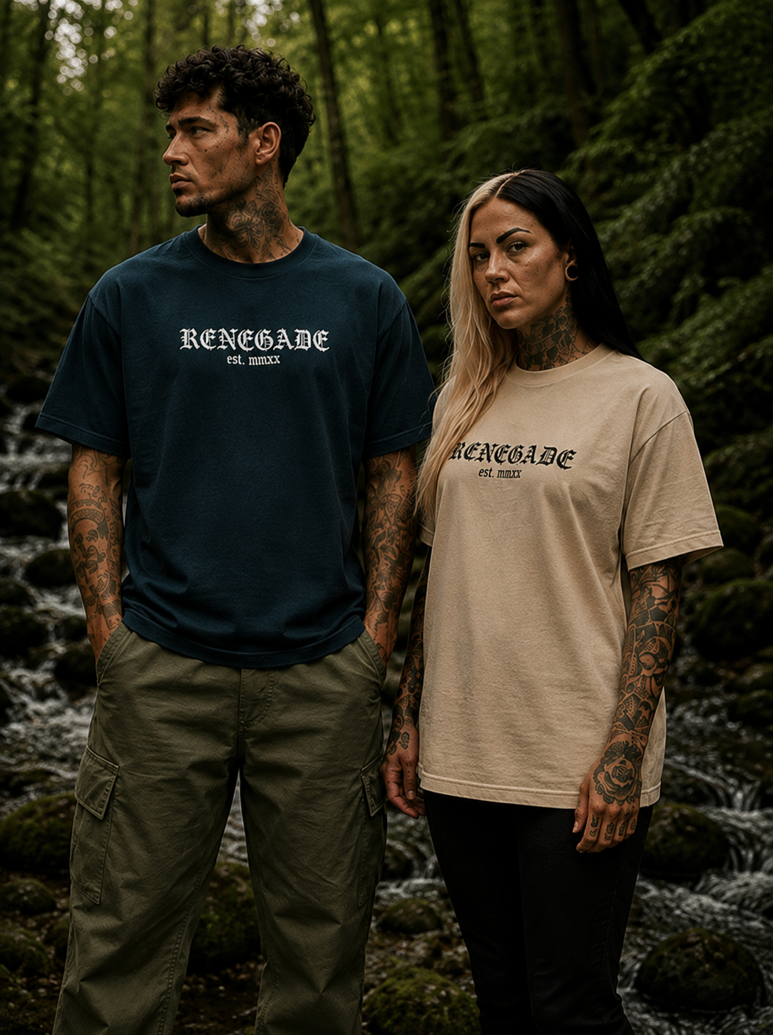 Male model in Petrol Blue Renegade Logo Tee and female model in Stone Renegade Logo Tee beside a woodland stream