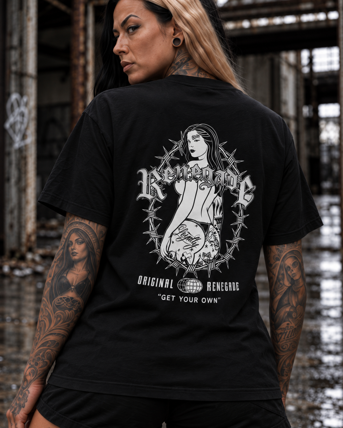 Trouble black graphic tee back print close-up on tattooed model in industrial setting